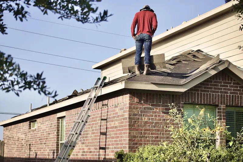 Professional roofer working on a residential roof in Pitcher